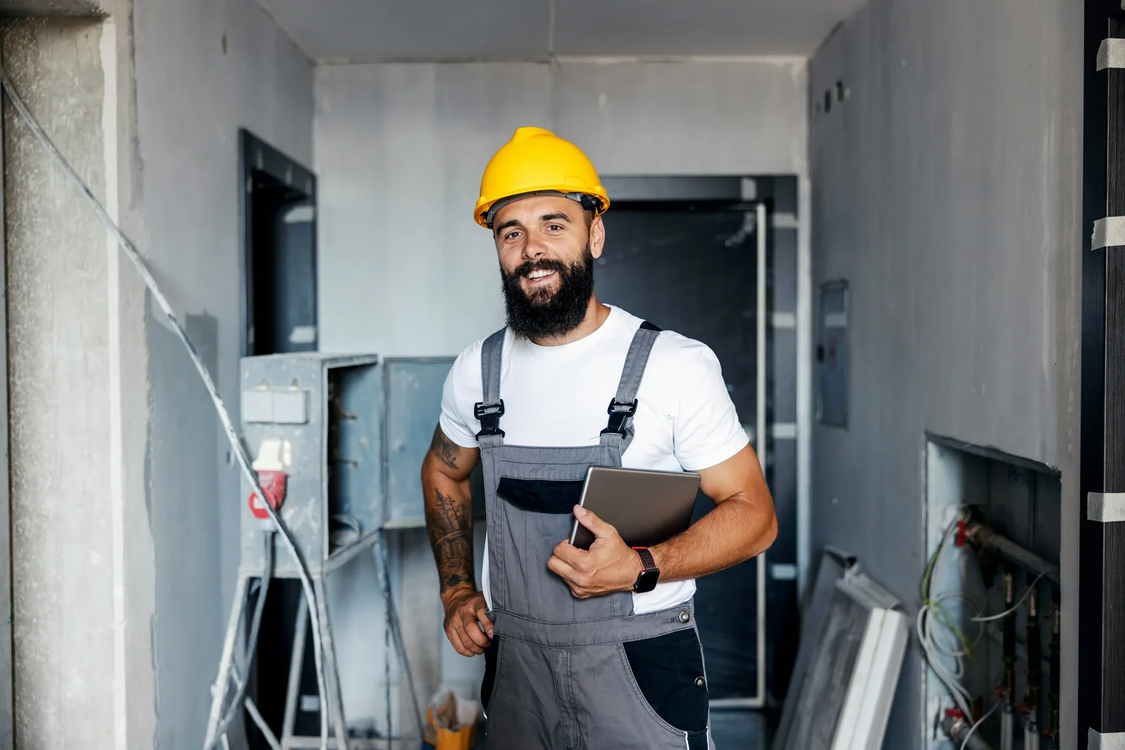 Electrician reviewing a job on a tablet